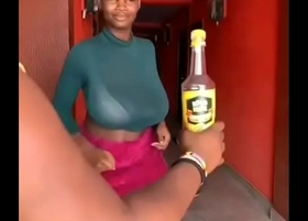 Ghana girl opens a bottled drink with her breasts